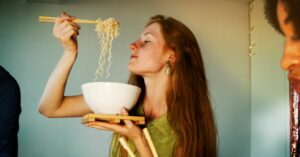 (woman eating pho)